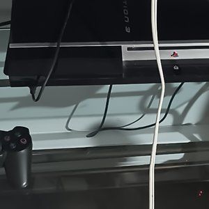 PS3 gaming console with two controllers